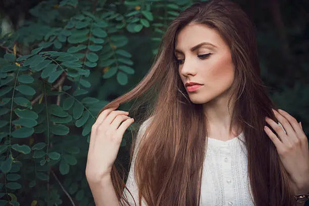 Portrait of a beautiful young woman with a strong healthy hair.